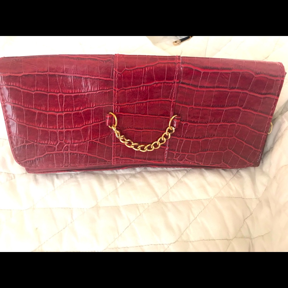 Red clutch with gold chain detailing